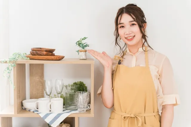 商品を笑顔で案内する女性スタッフ