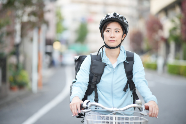 自転車でデリバリーを行う女性スタッフ
