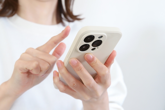 スマートフォンを操作する女性の手元